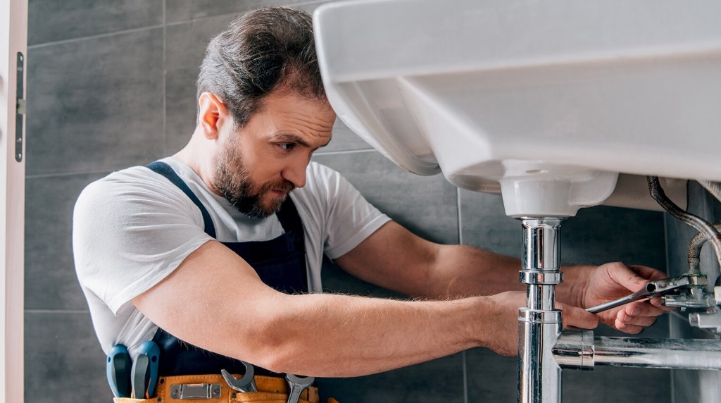 Plumber fixing sink