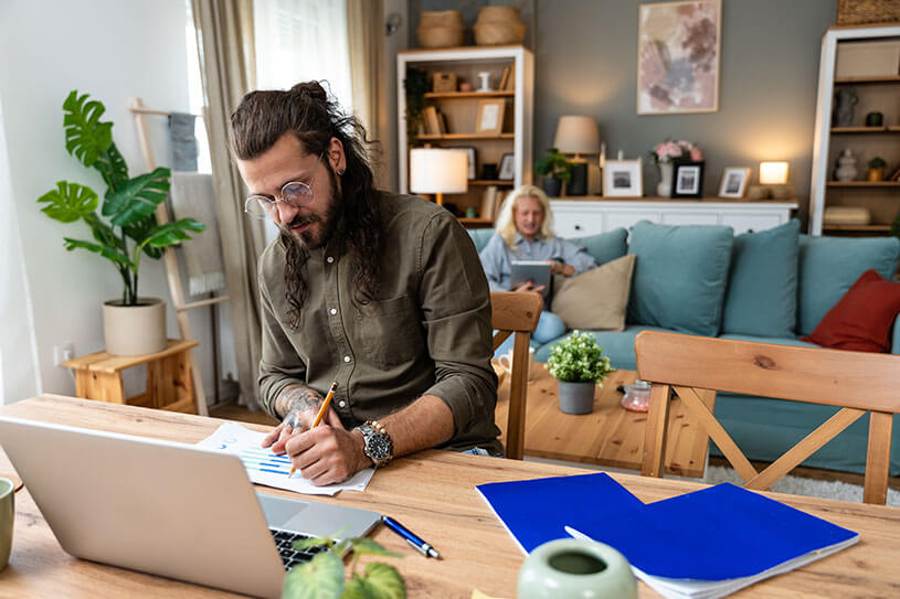 Small business owner, working online at home office using laptop