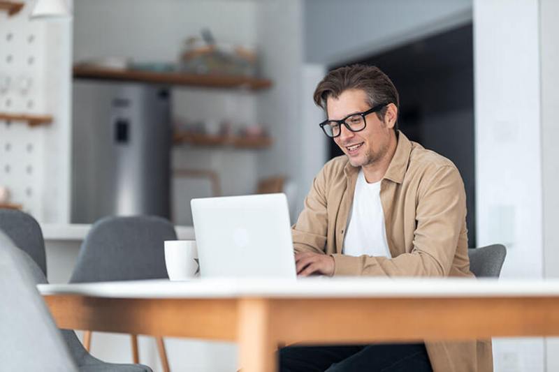Business owner works from home on his laptop