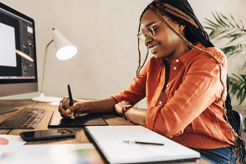 Woman designing on tablet