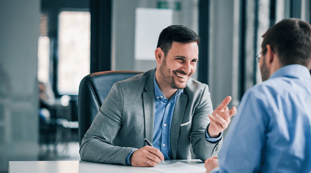 Commercial insurer talking to a client in an office