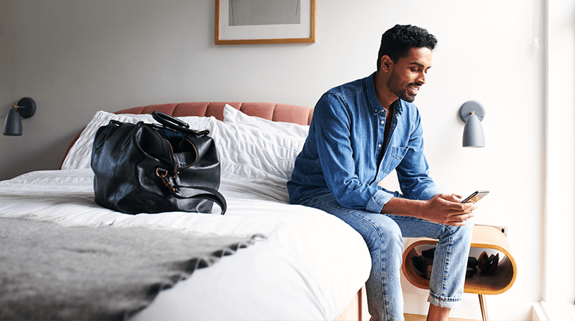 Guest sitting on a hotel bed