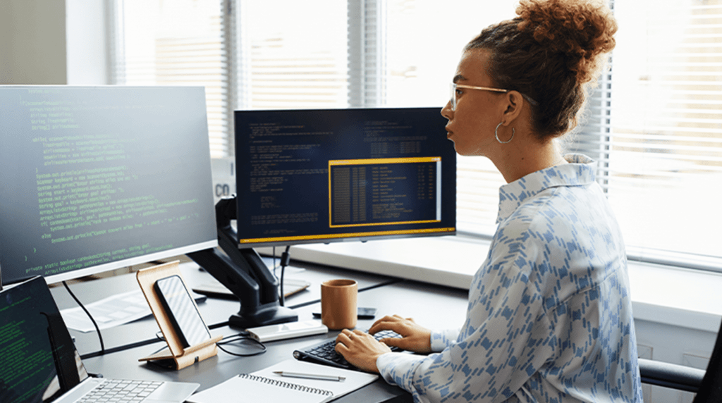 A web publisher typing code at a computer