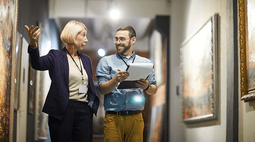 Museum workers making a note of the artwork on display