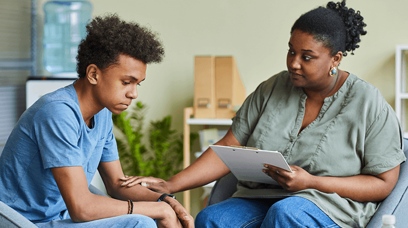 Psychotherapist talking to a young boy