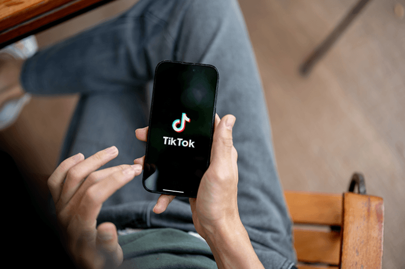 A small business owner goes on TikTok on their phone